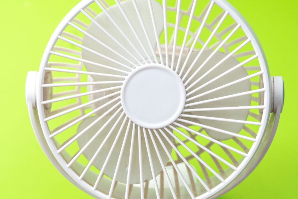 white battery fan on green background