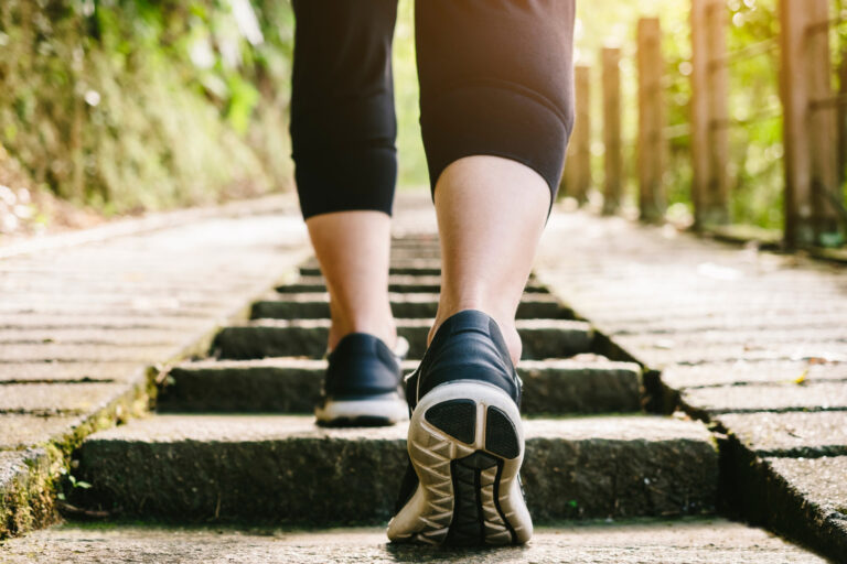 calves and shoes on walking trail