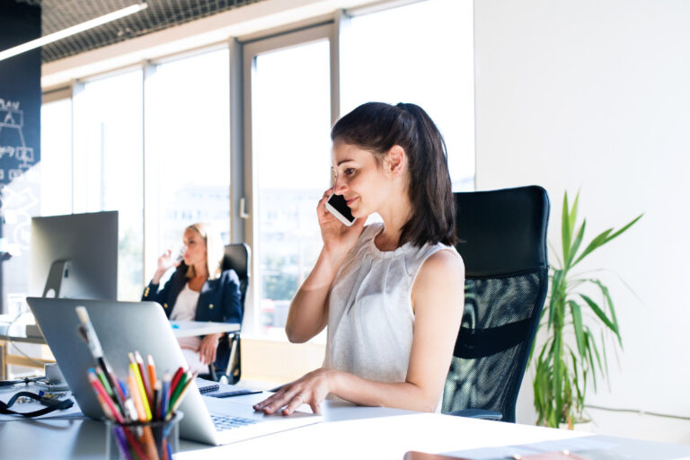 woman on phone at workspace